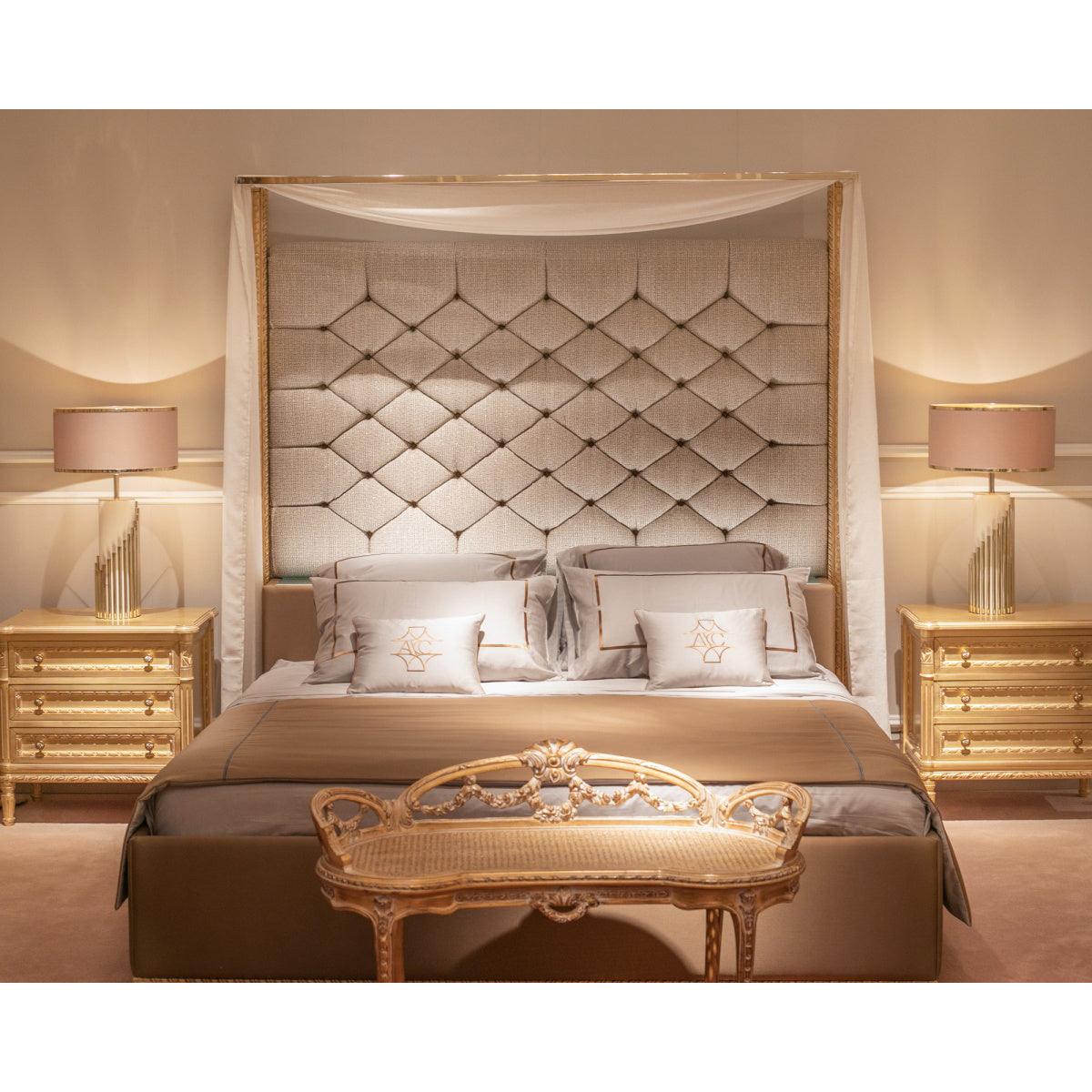 Pair of Streamline lamps beside a tall upholstered bed