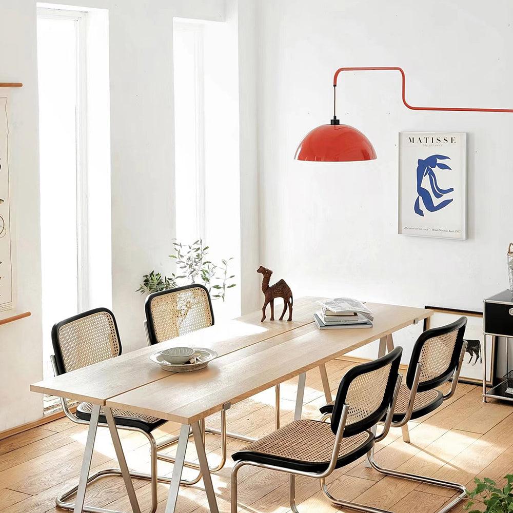 Red Elio wall light over a bright dining setting