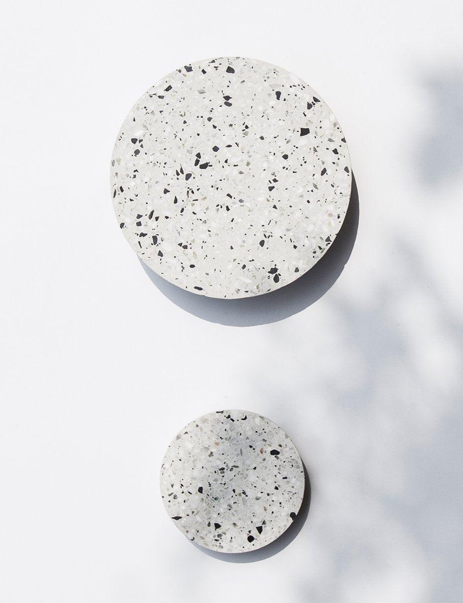 Two White chip-patterned discs in different sizes