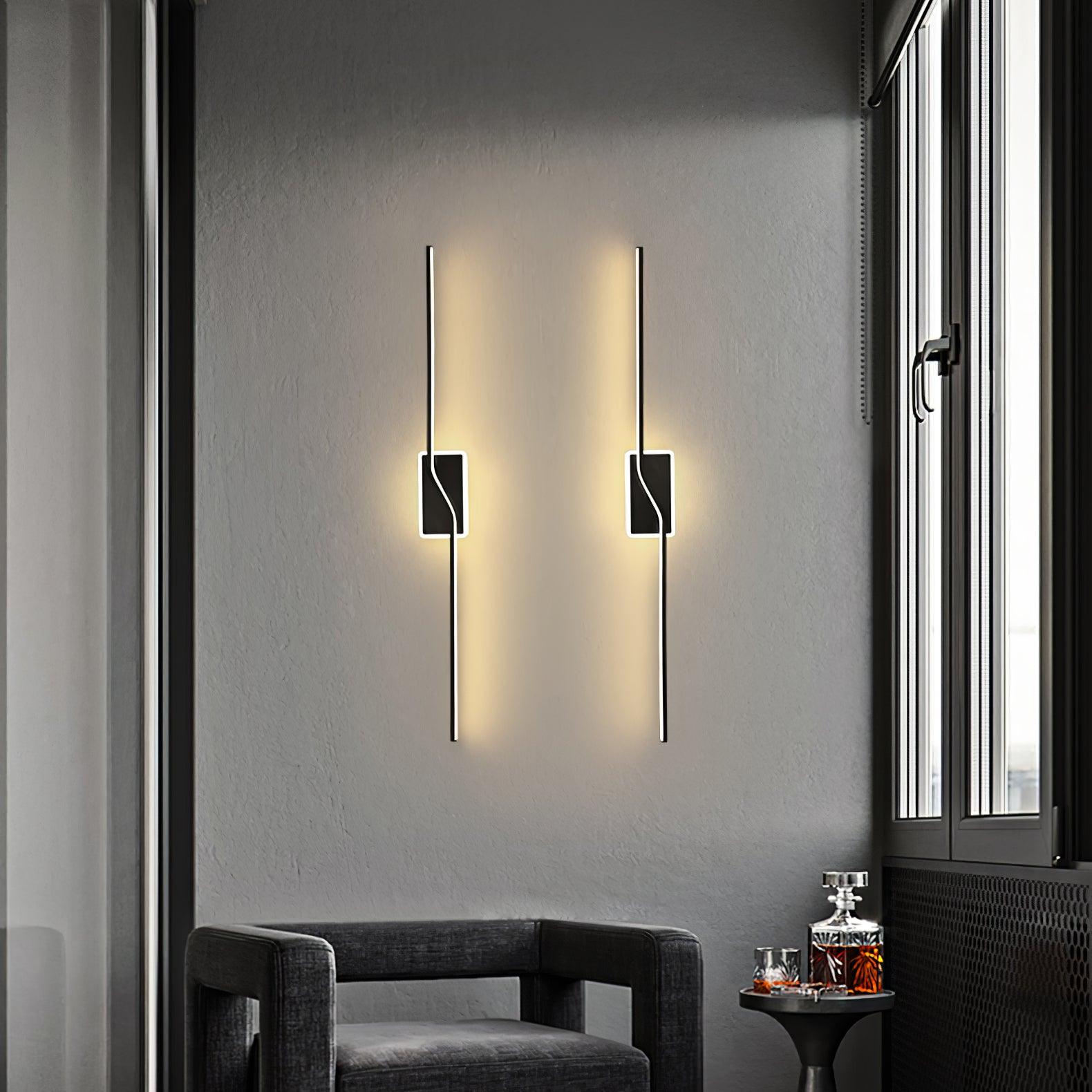 Pair of vertical Black wall lights above an armchair