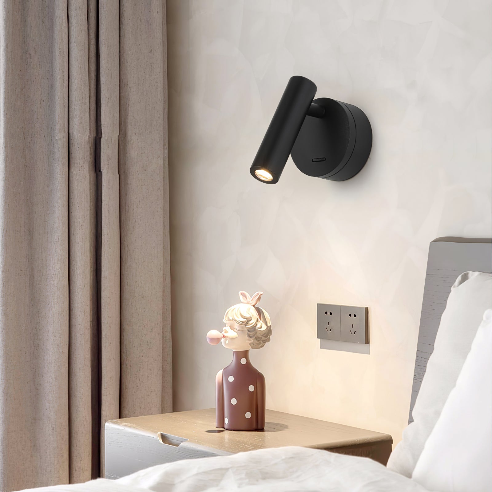 Black reading spotlight above bedside furniture