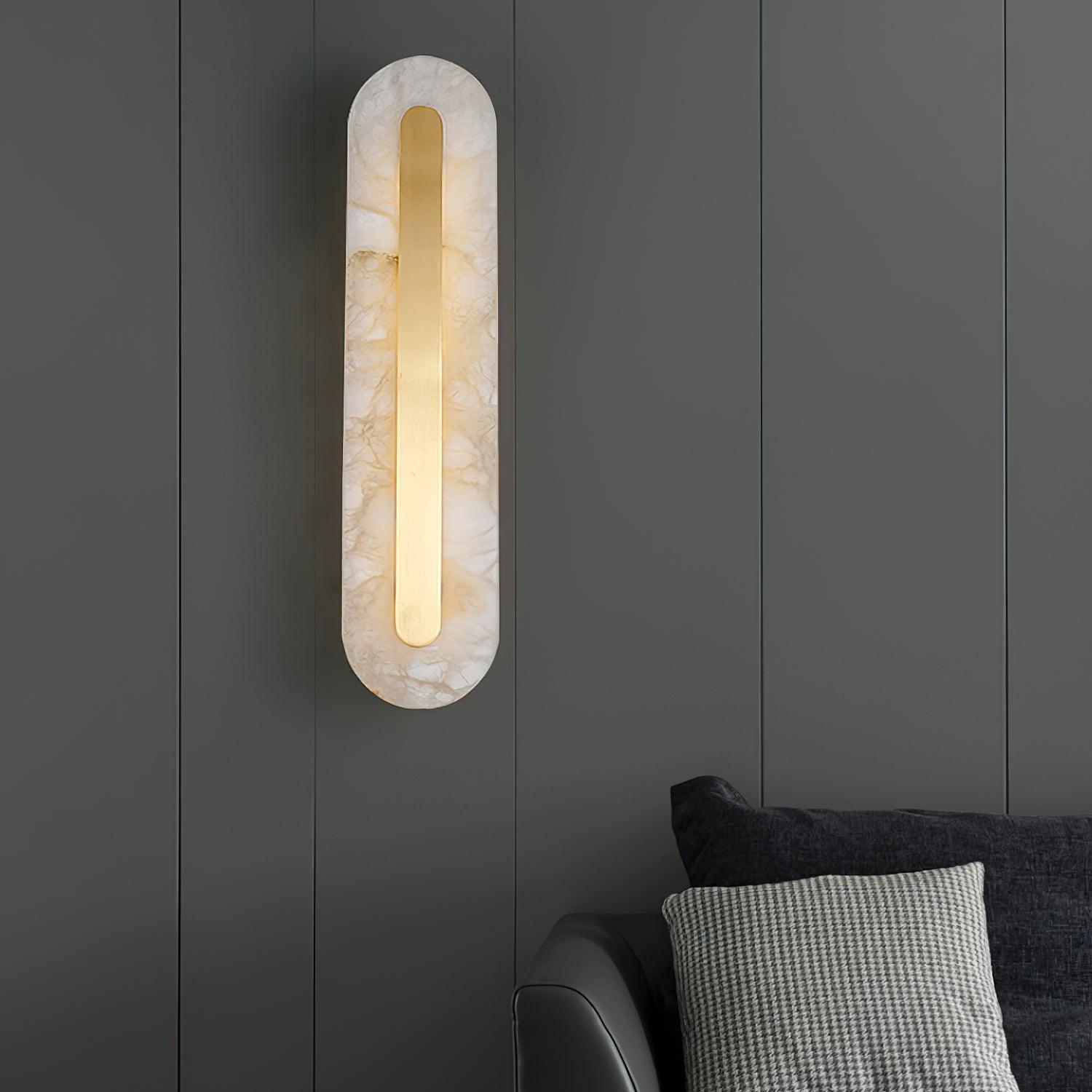 Rounded wall light over a dark sofa