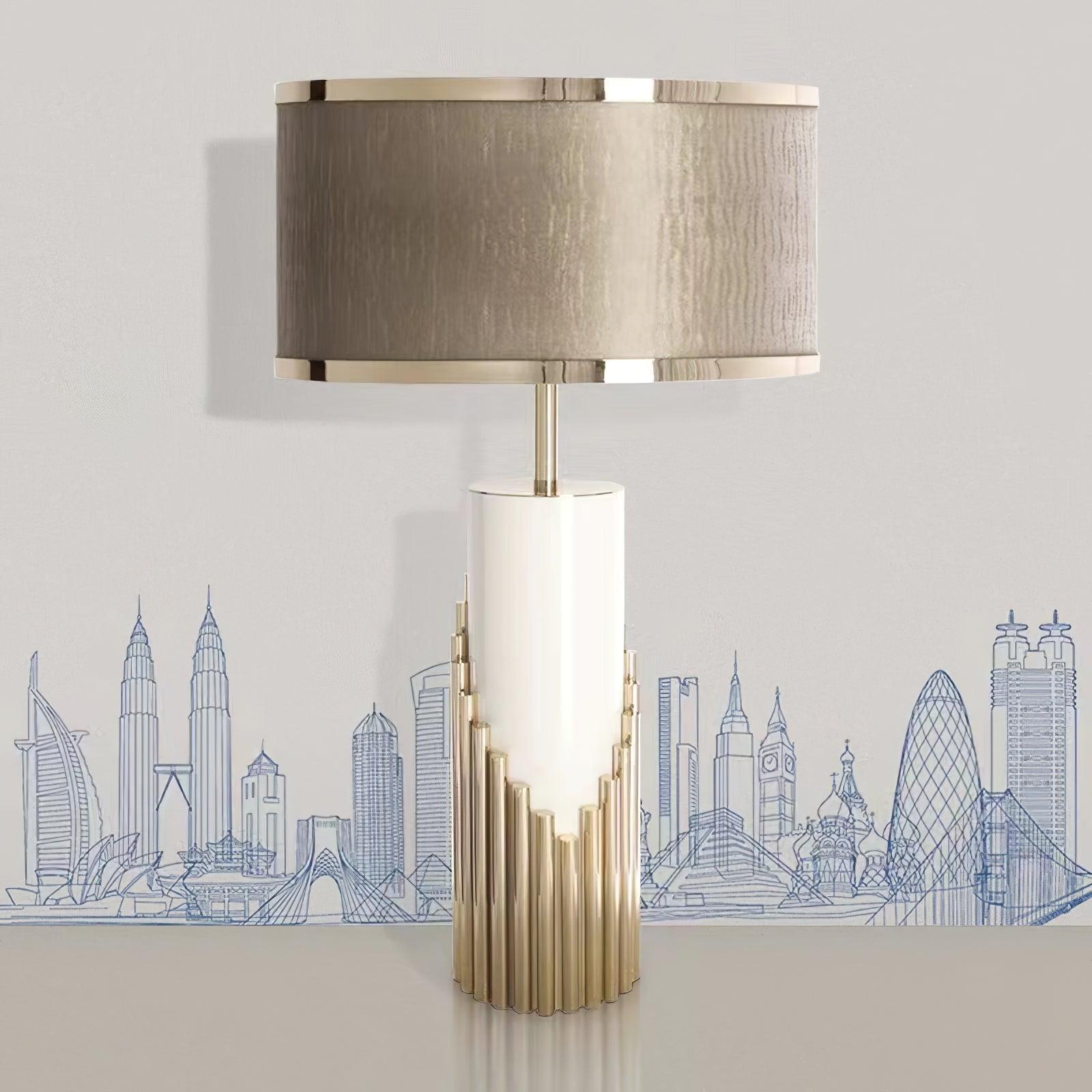 Streamline lamp with pale column and stepped Gold base against a city graphic