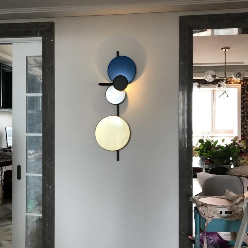 Blue disc fixture lit beside an interior doorway