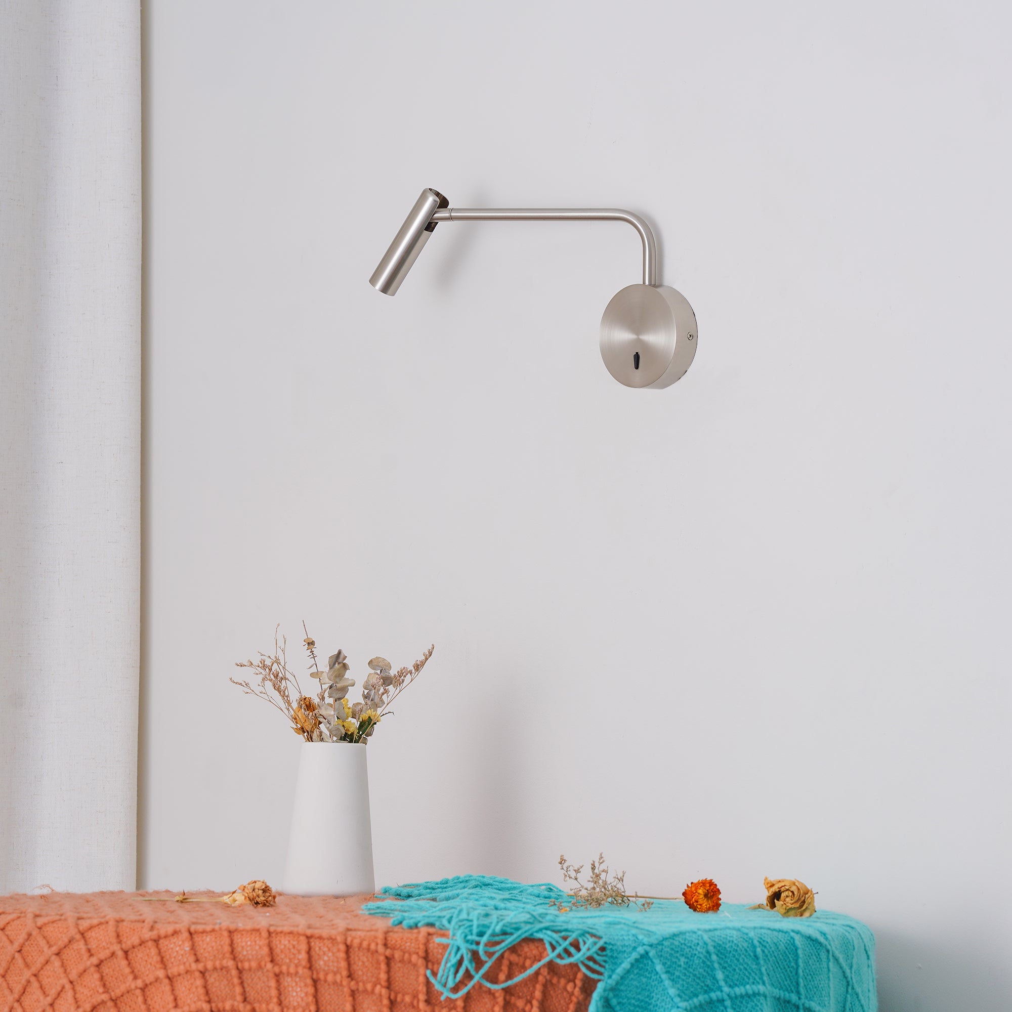 Tilted metal head above a fabric-covered surface