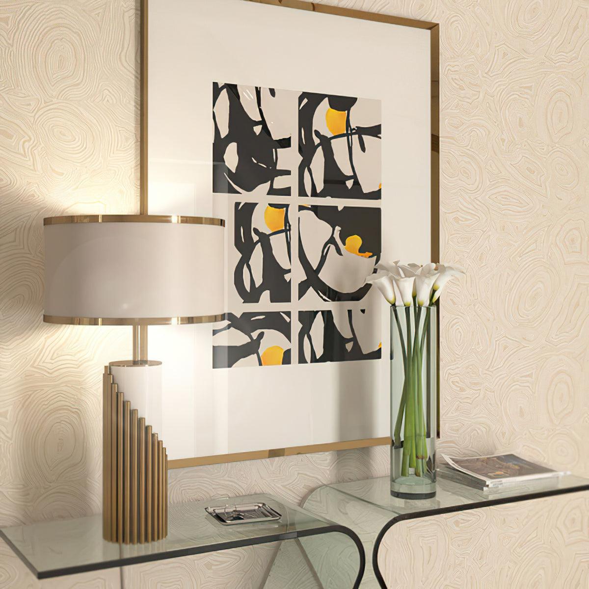 Streamline table lamp on a console beside framed abstract art