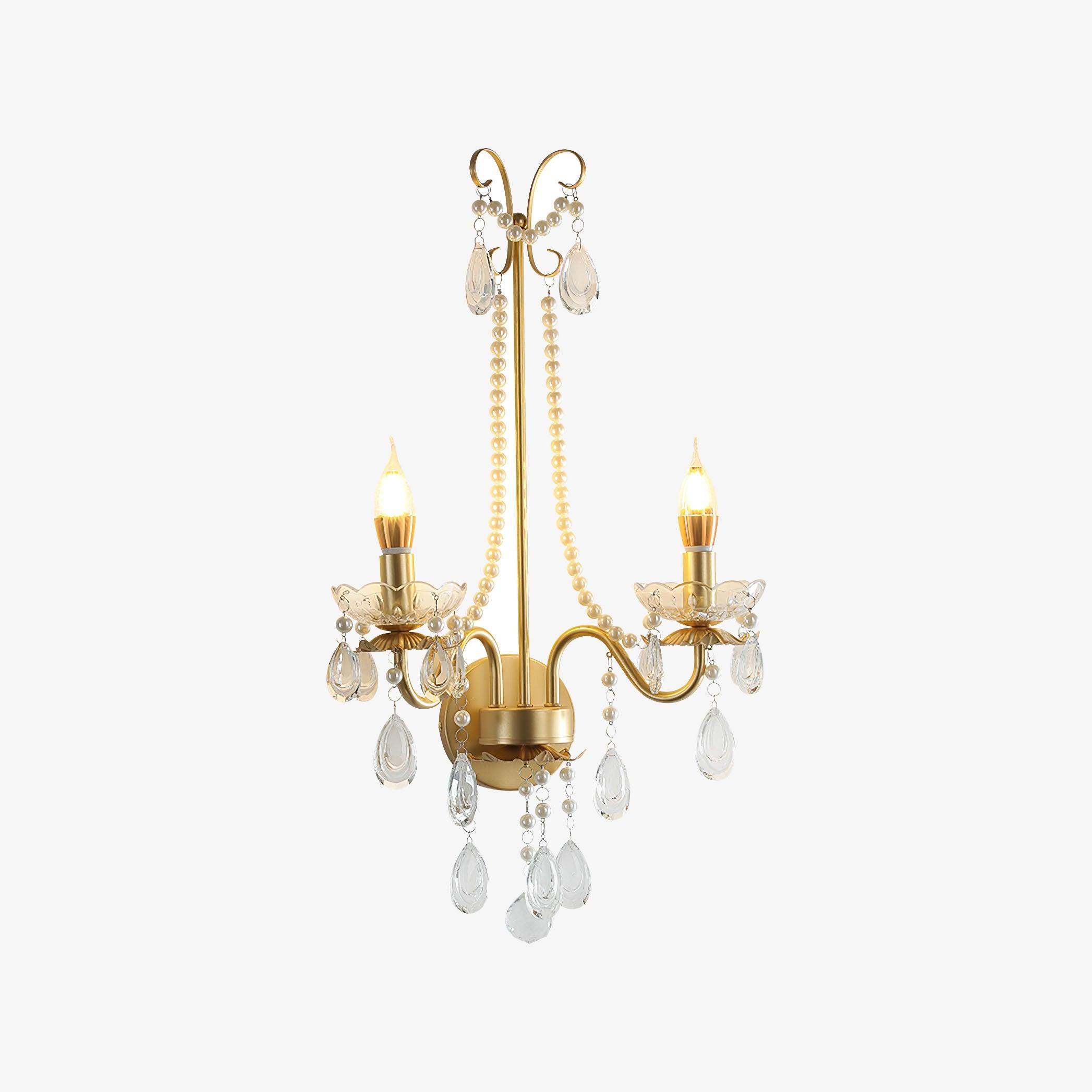 Large isolated lit gold-and-clear wall light on white, with two candle arms, scalloped bowls, long bead chains and hanging drops