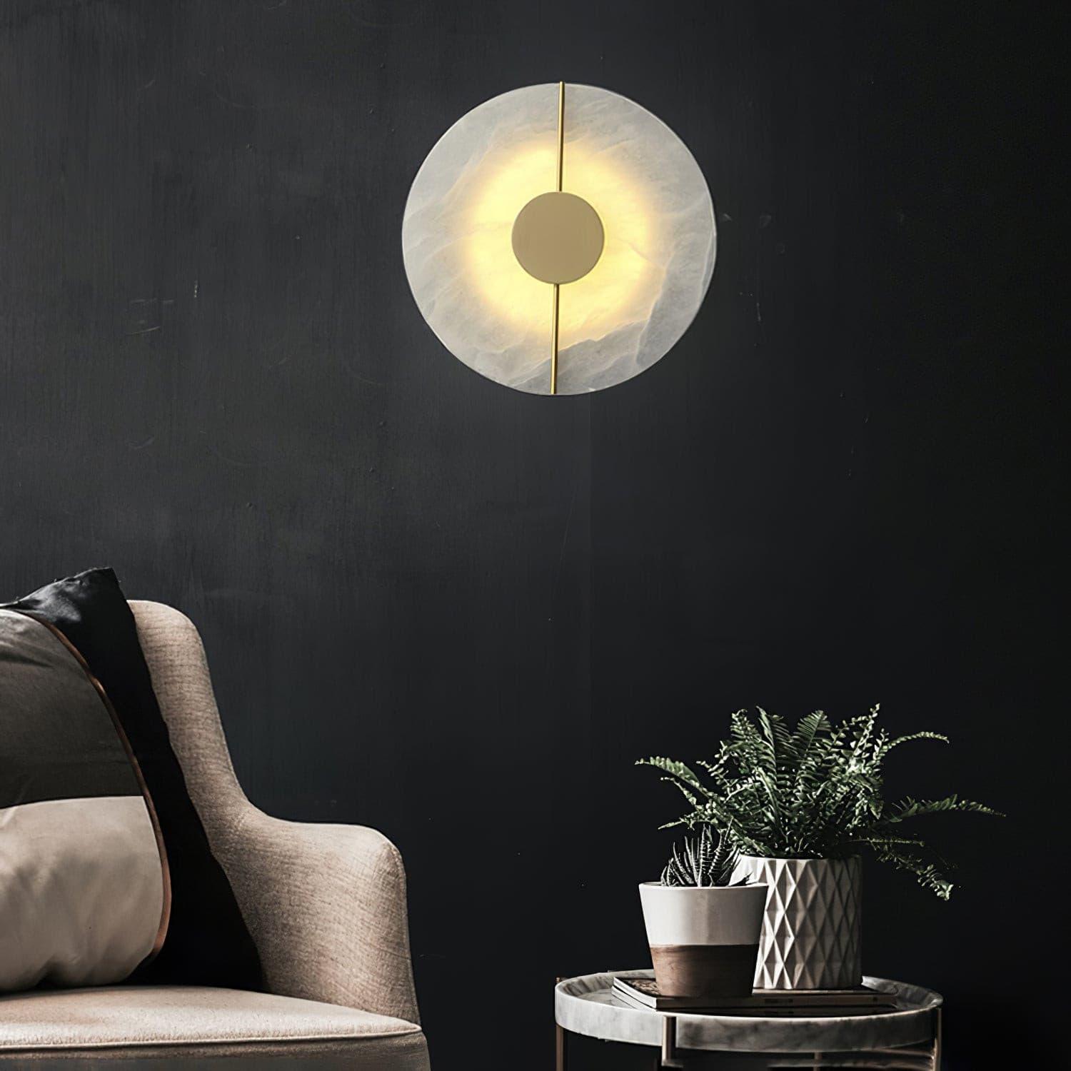 Round patterned wall lamp against a dark wall