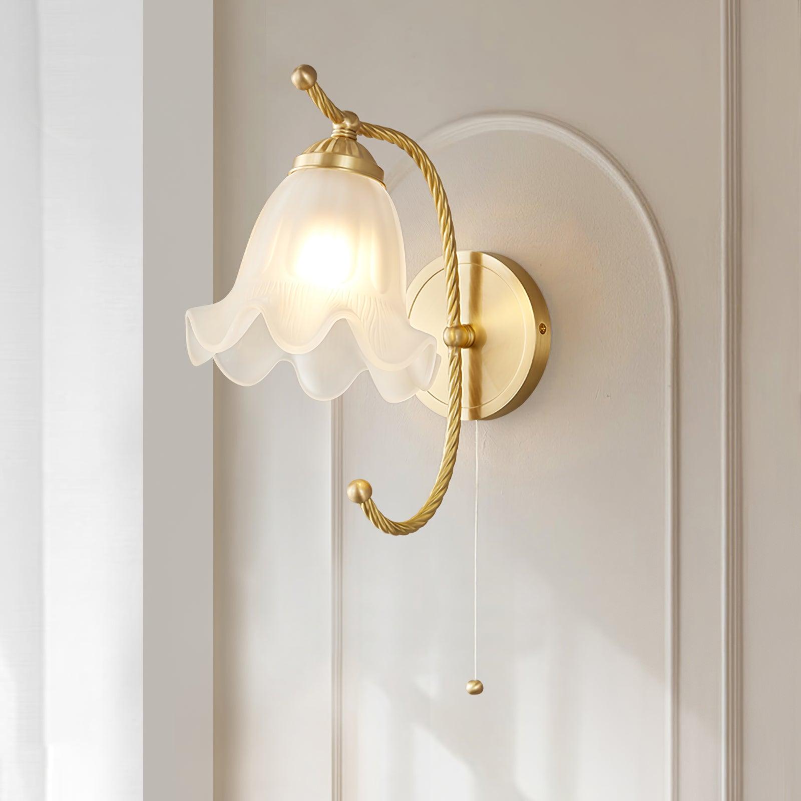 Close lit brass gooseneck lamp on arched wall panelling, with white scalloped glass shade and pull cord ending in a round knob