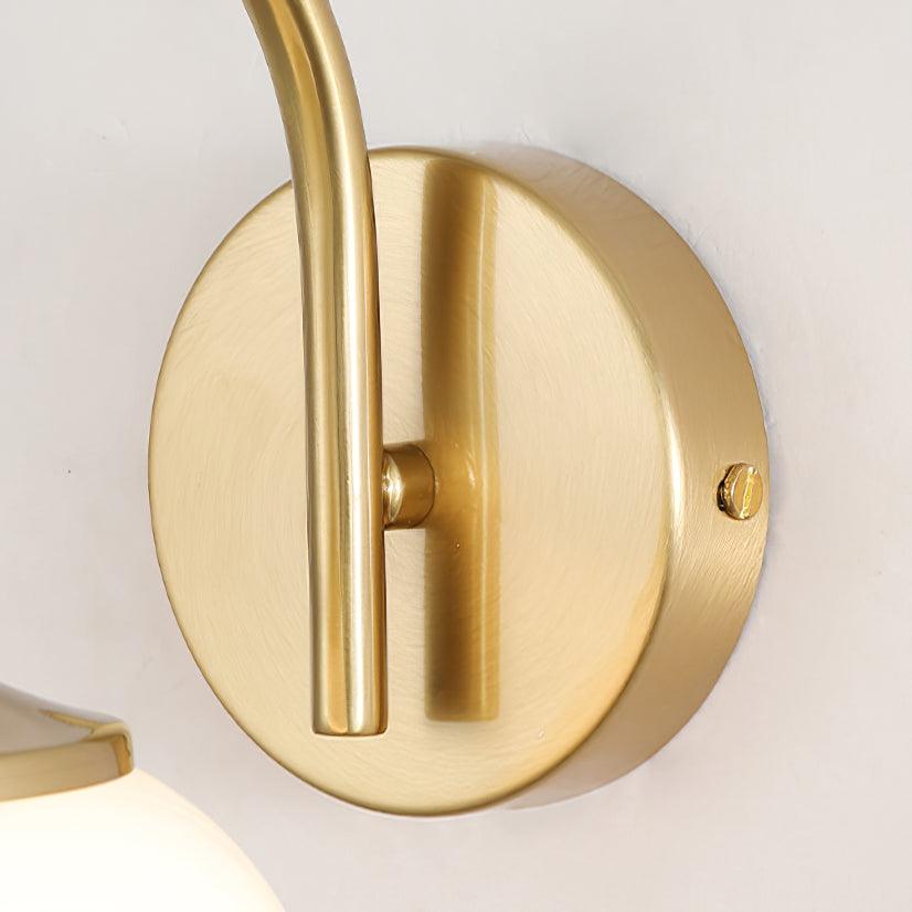 Close-up of brushed gold-coloured wall plate, curved arm and side screw