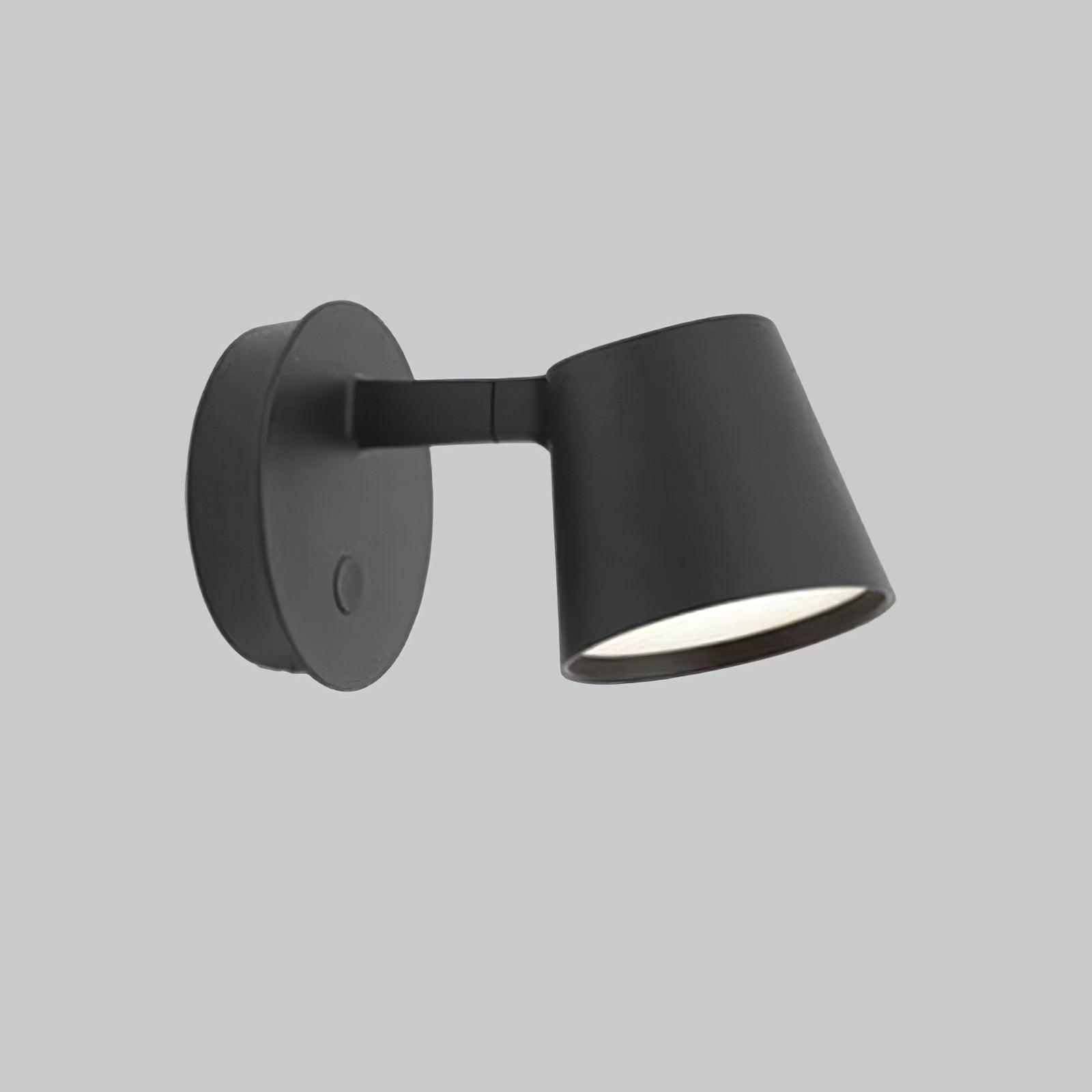 Close black Tip wall light on grey background, showing short-arm joint seam and white light-emitting face