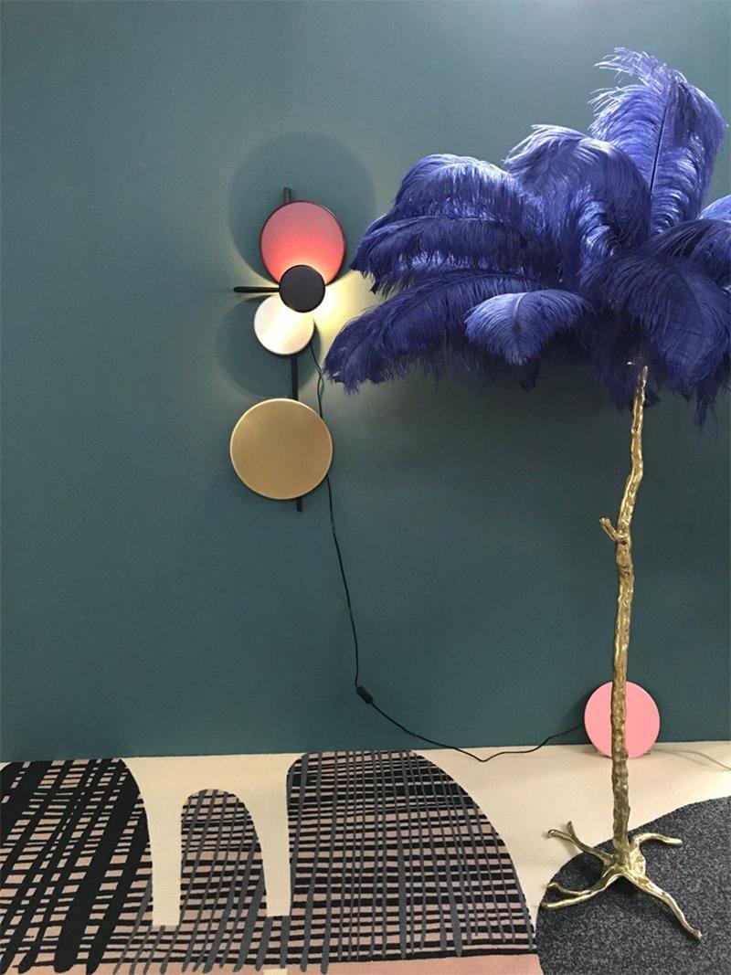 Small disc fixture beside blue decorative feathers
