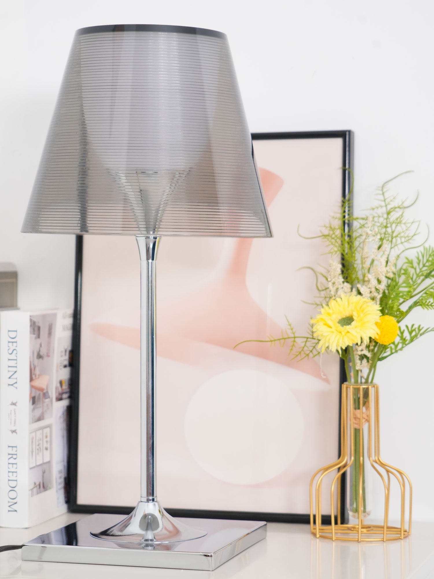 Chrome Prism grey shade and reflective stem against framed art