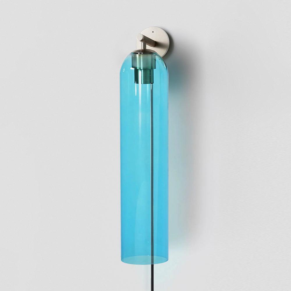 Sky blue glass shade around the inner fitting of a sand nickel wall light