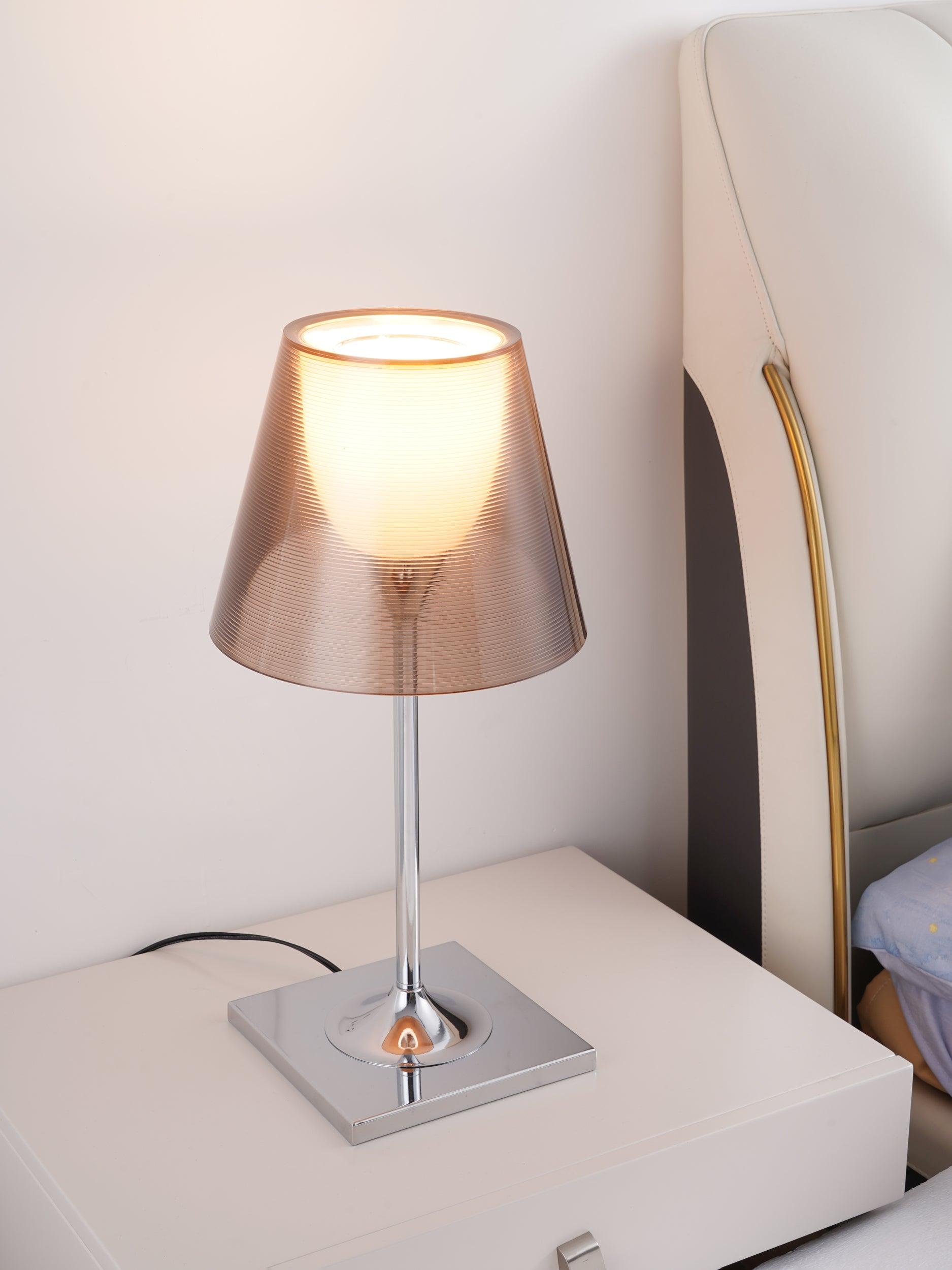 Angled view of the lit Bronze Chrome Prism table lamp