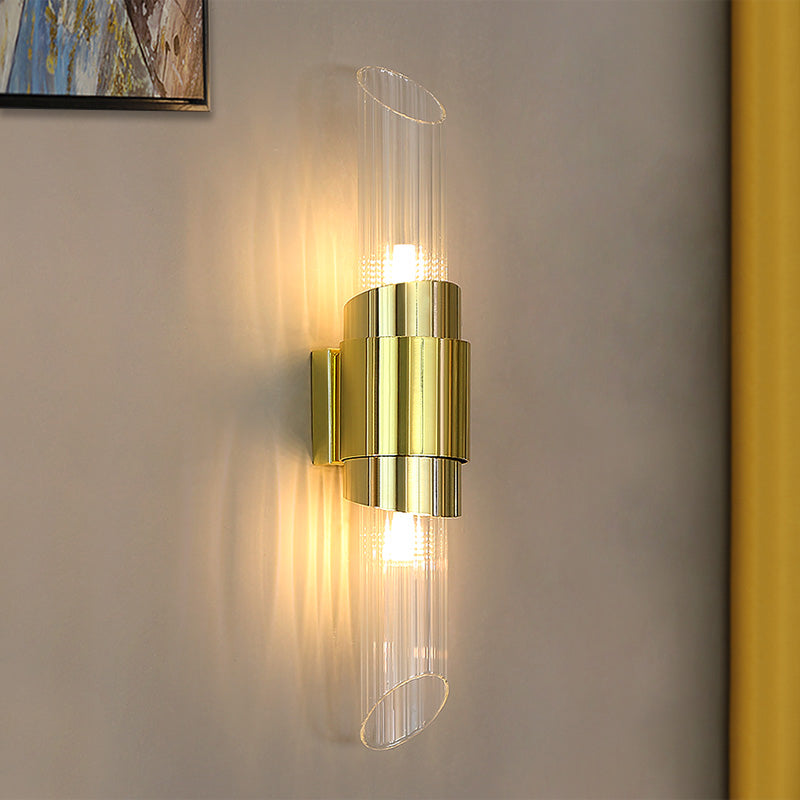 Lit Gold crystal tube wall light on grey wall, with streaked glow, cropped abstract art at top left and yellow curtain at right