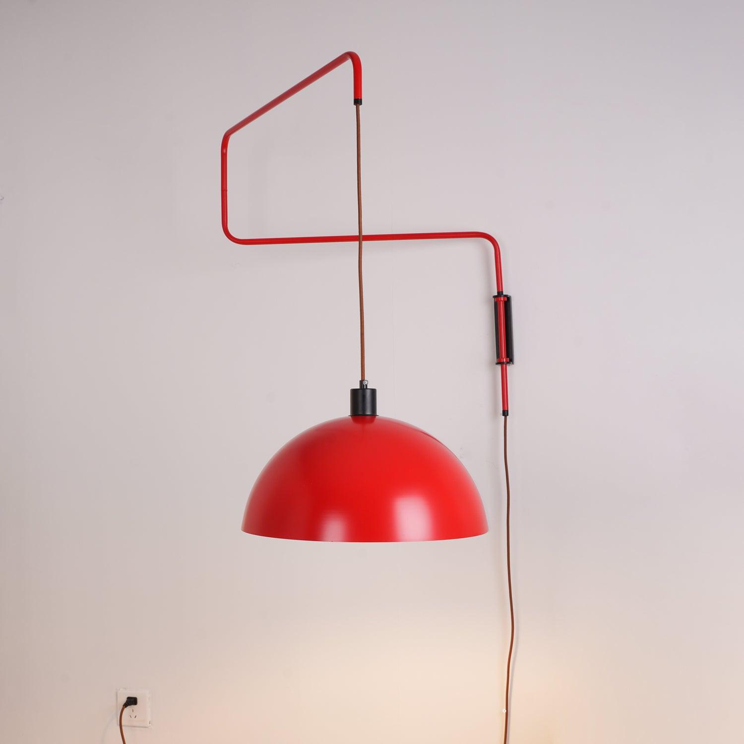Red wall lamp with hanging cord and plug