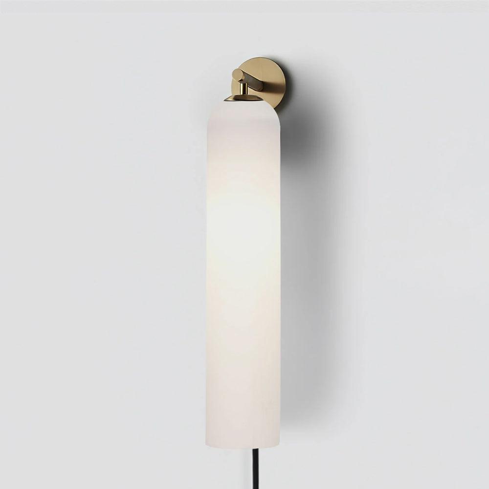 Milky white cylindrical wall light on a gold mounting plate