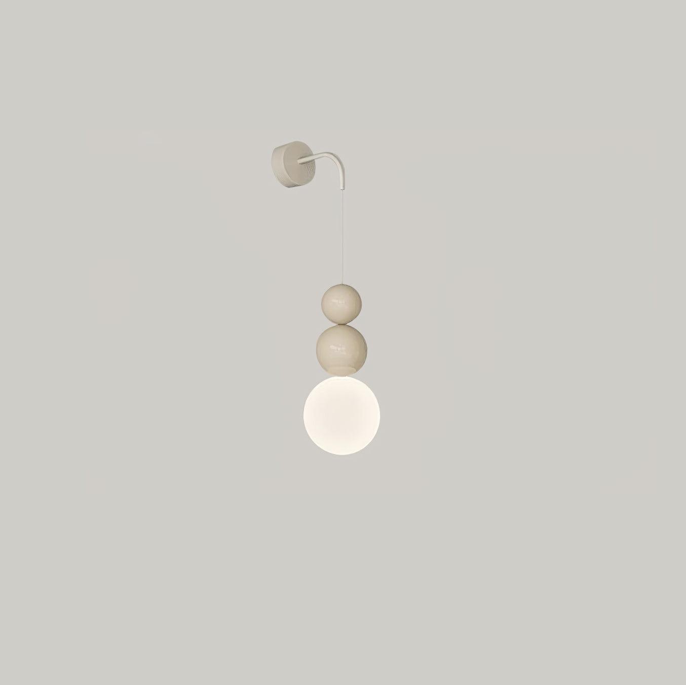 Beige Three Ball wall light with a white lower globe beneath two beige spheres on a grey background