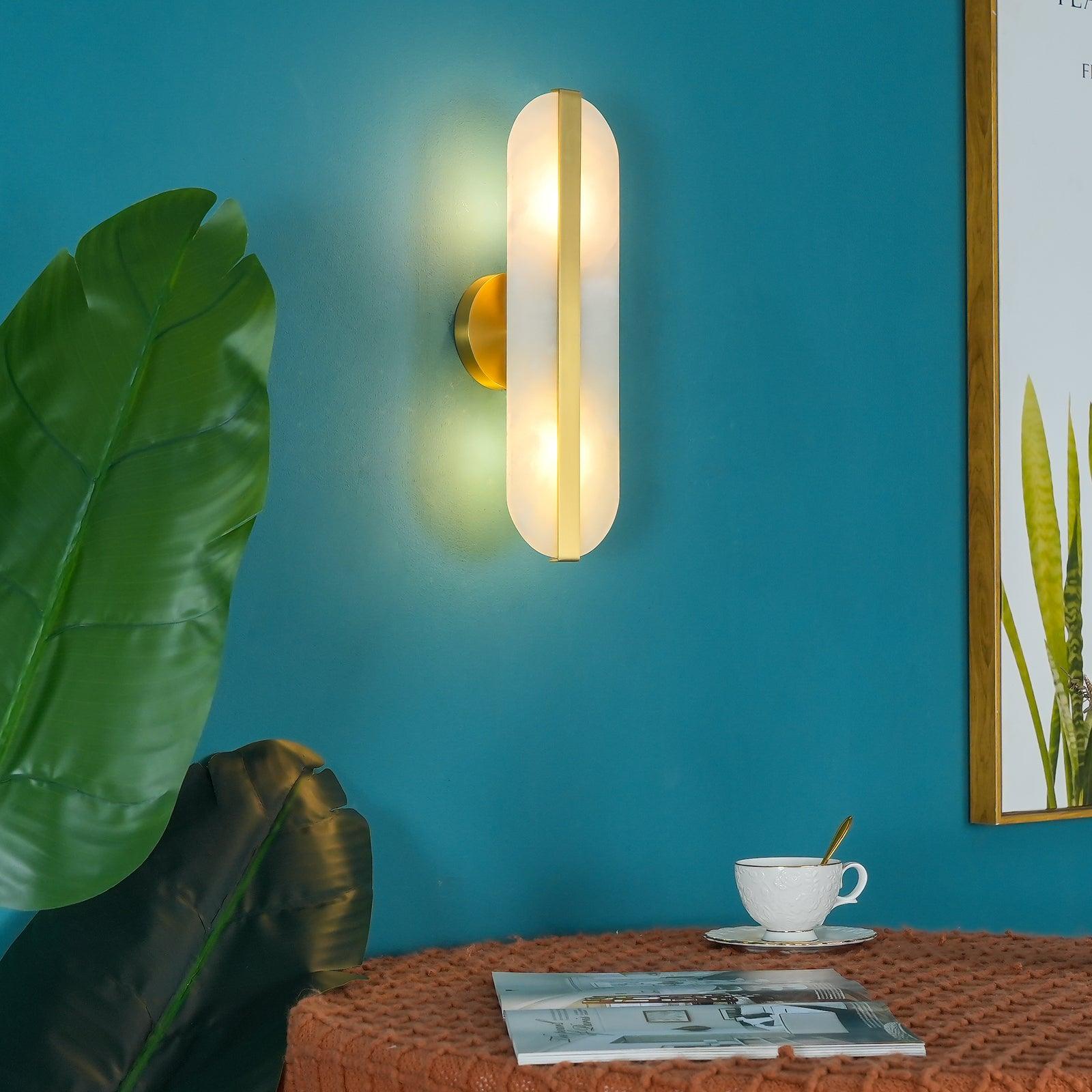 Lit Brass and White sconce above a side table