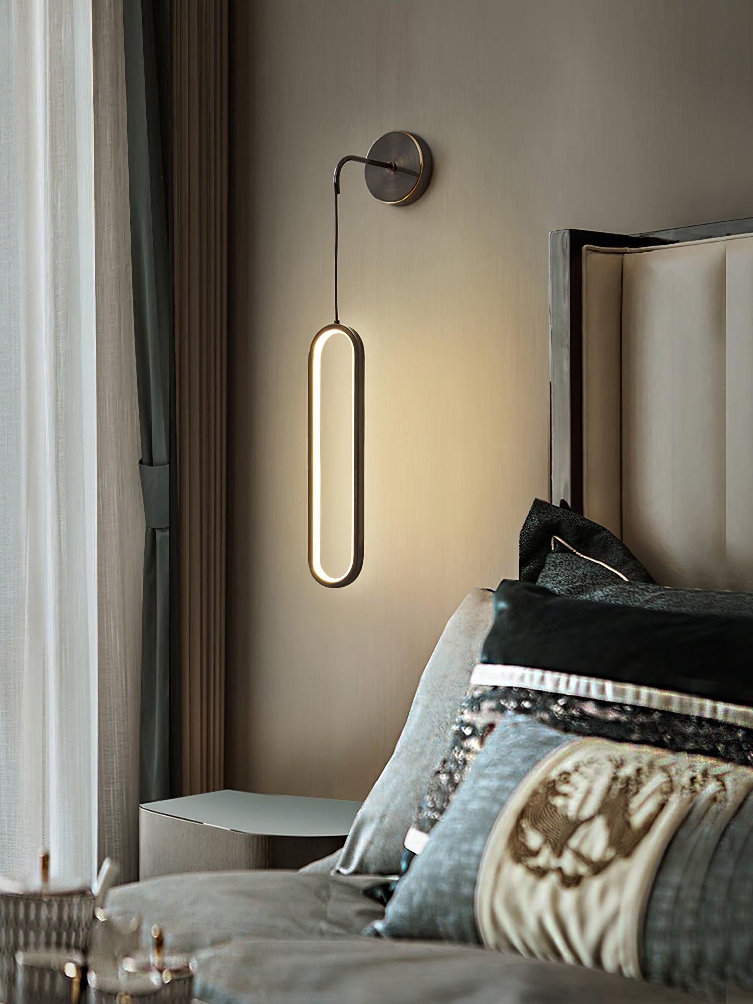 Black-option wall light above a bedside table