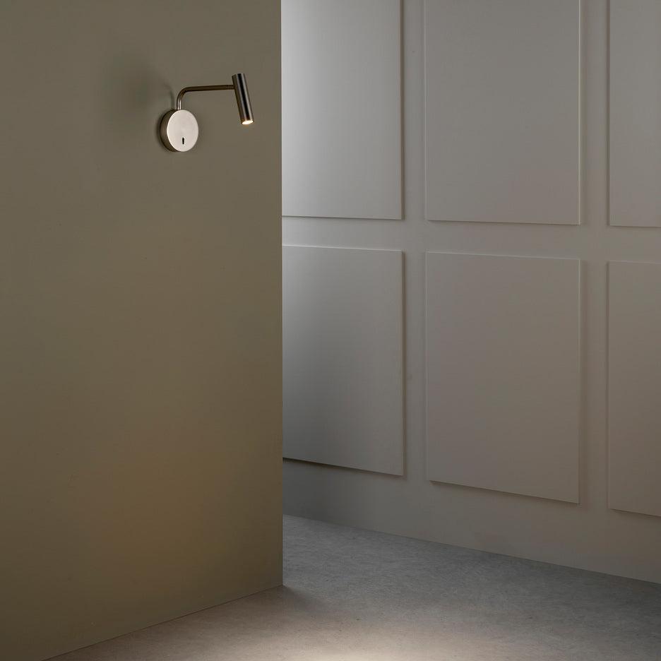 White wall fixture against a grey interior wall