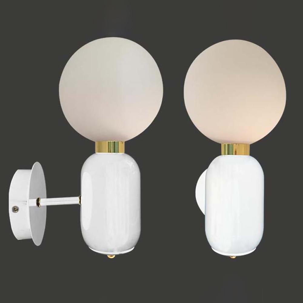 Side and front views of white Aballs sconce on dark background, white globe, rounded body and gold-tone collar