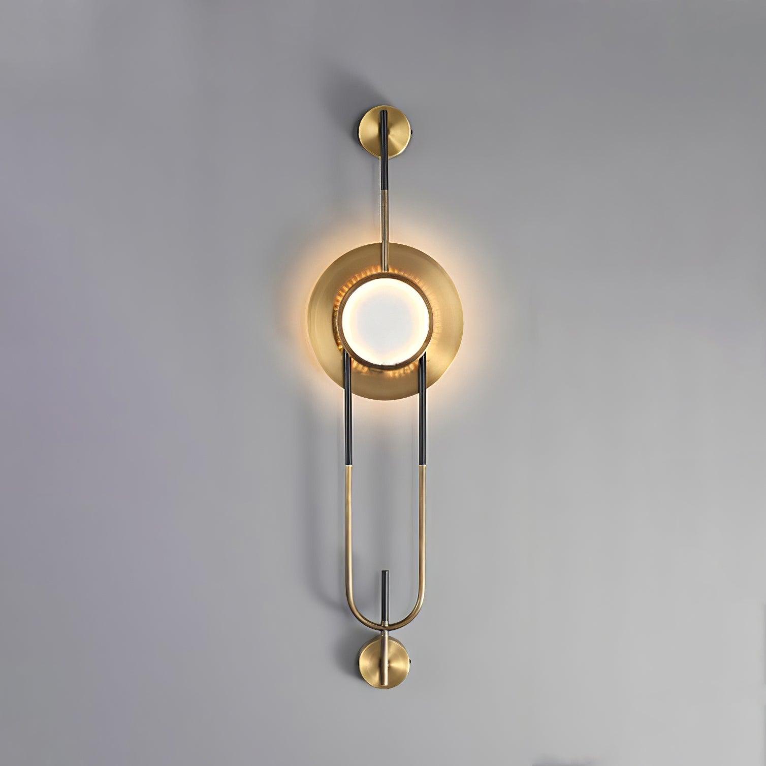 Compact illuminated marble wall light against gray, showing the circular shade and black-and-gold loop frame