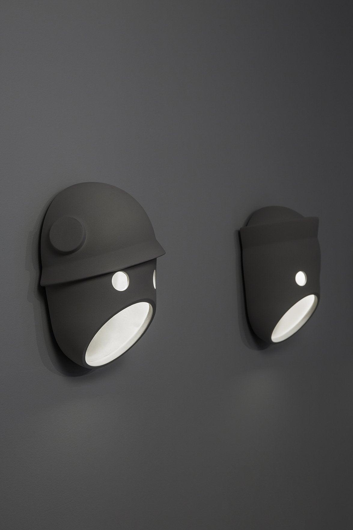Two illuminated face wall lights with different upper details