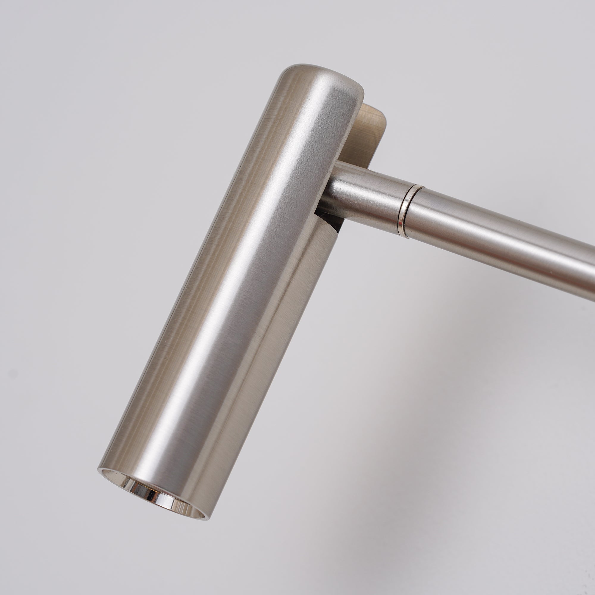 Close view of brushed cylindrical head and pivot joint