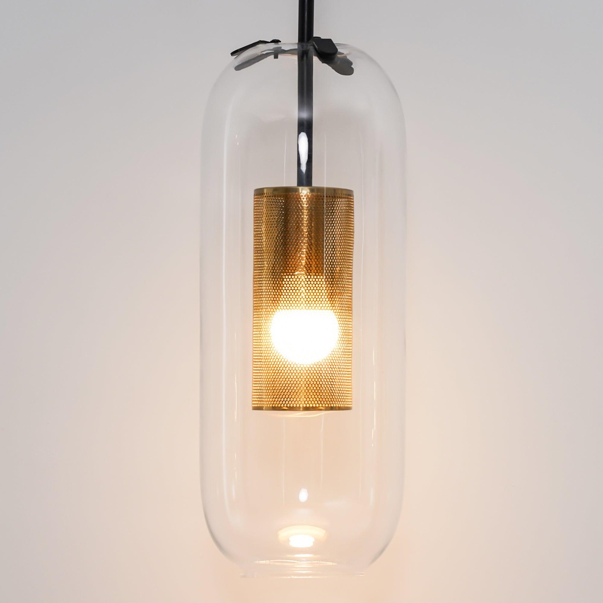 Closer view of Black Vadim shade-retaining clips, clear capsule glass and illuminated perforated metal cylinder