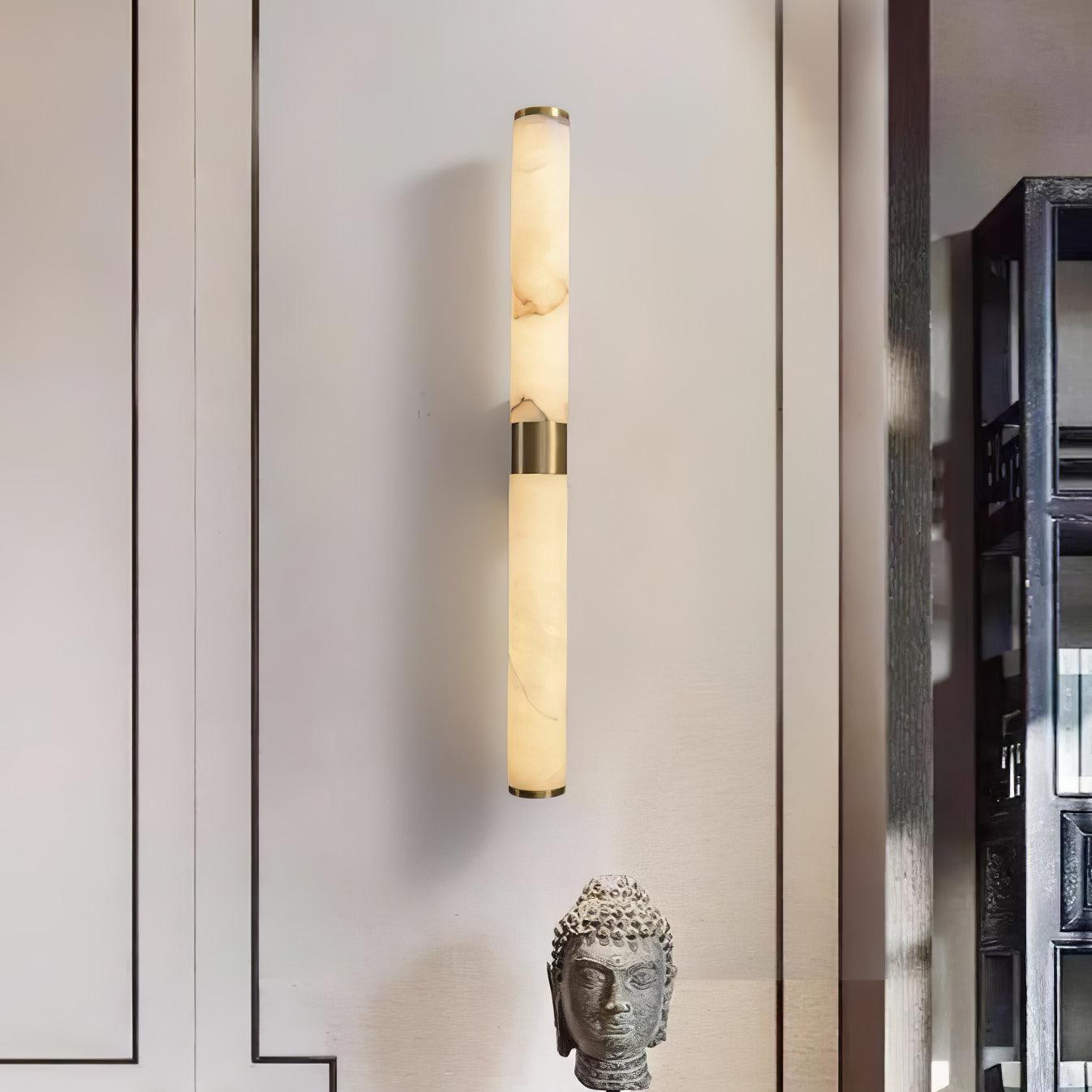 Line Alabaster light on a panelled wall above a sculpture