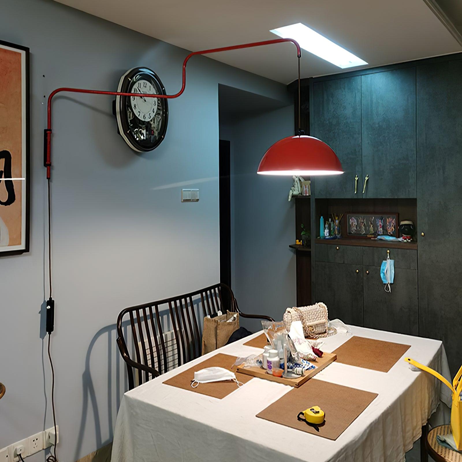 Elio wall lamp reaching over a dining table