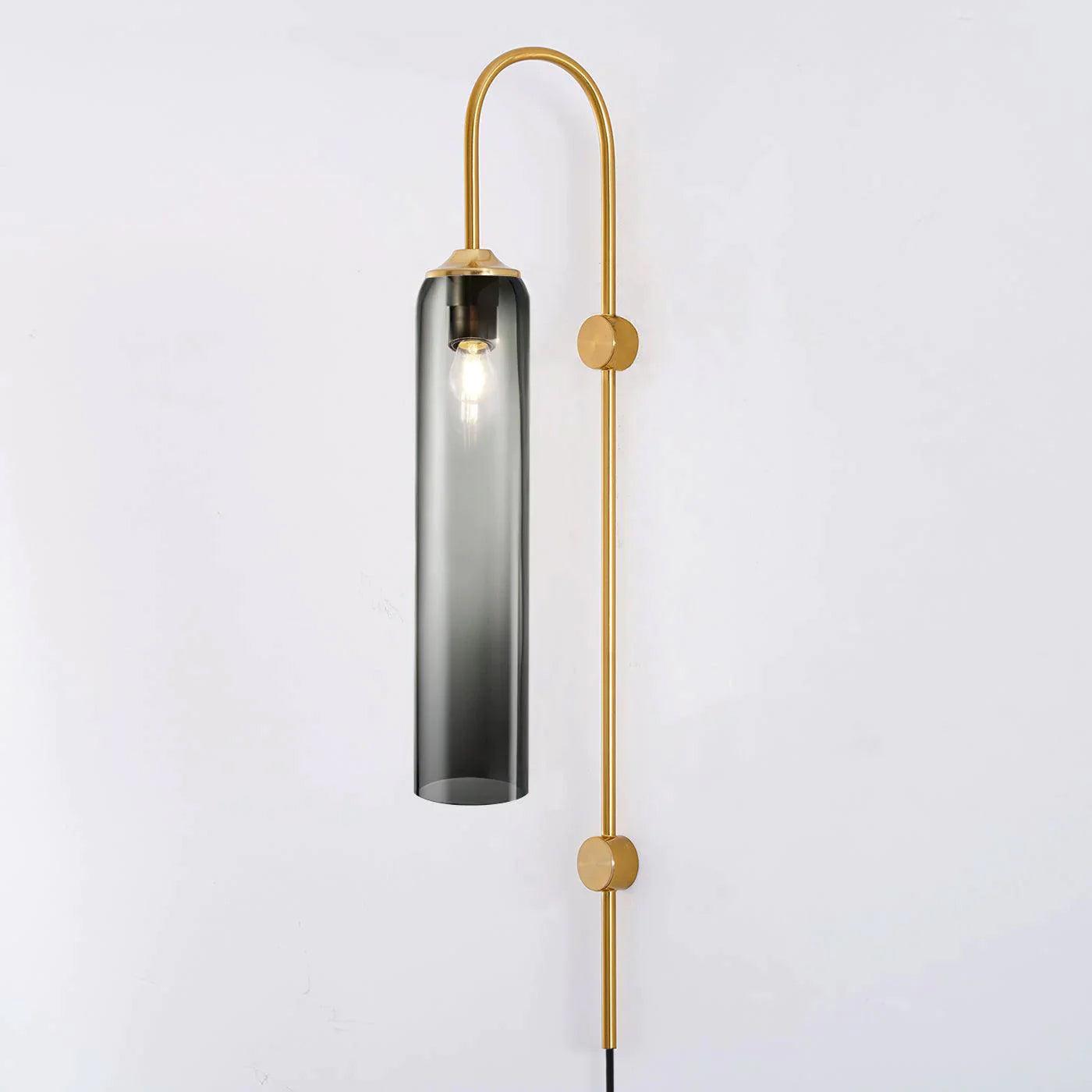 Smoky grey glass tube on a gold-coloured curved wall frame