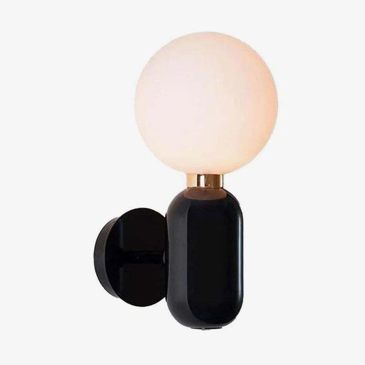Small black Aballs sconce on white, warm-looking globe, round wallplate, short arm and reflective collar
