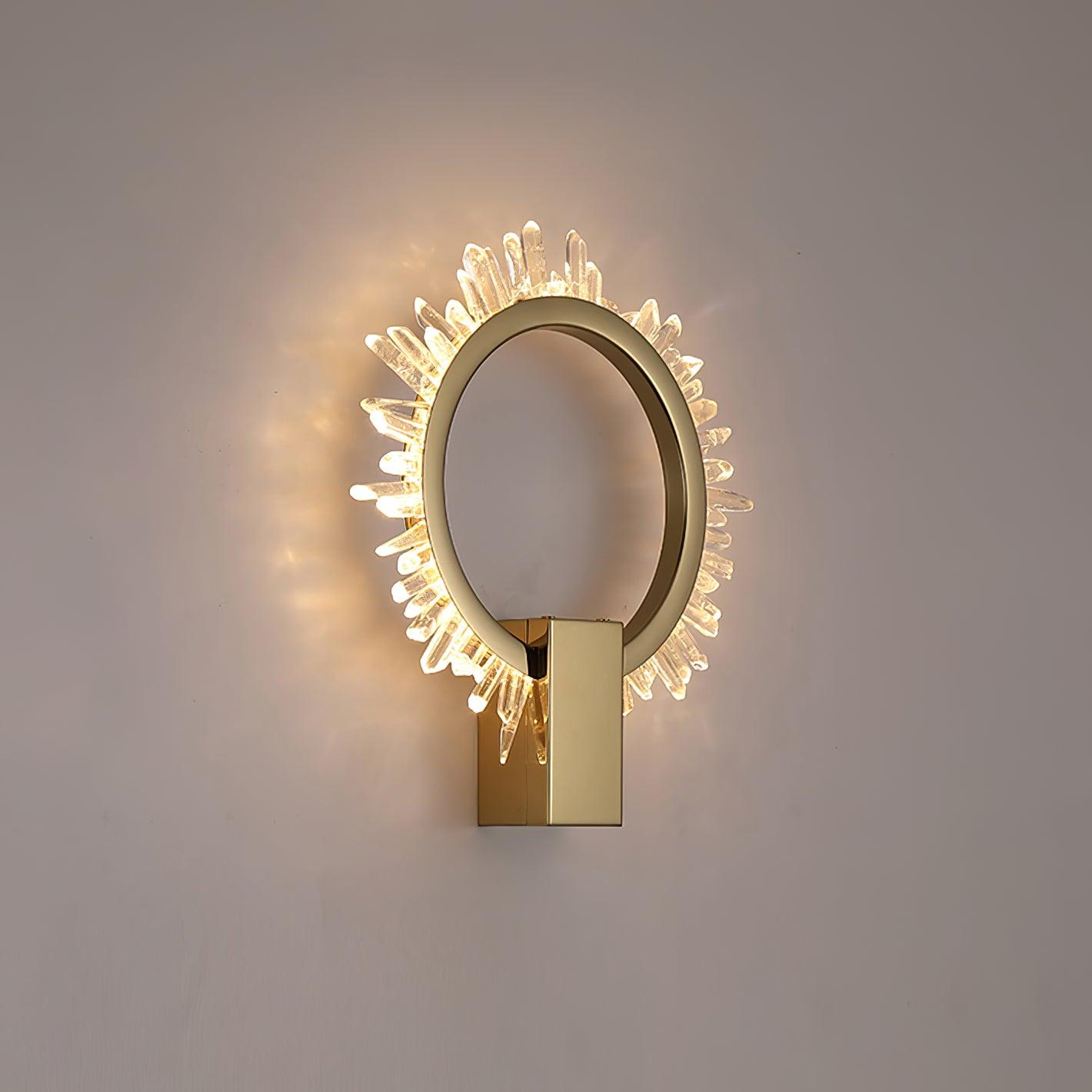Closer angled view of the illuminated clear crystal rim and gold ring on a pale wall