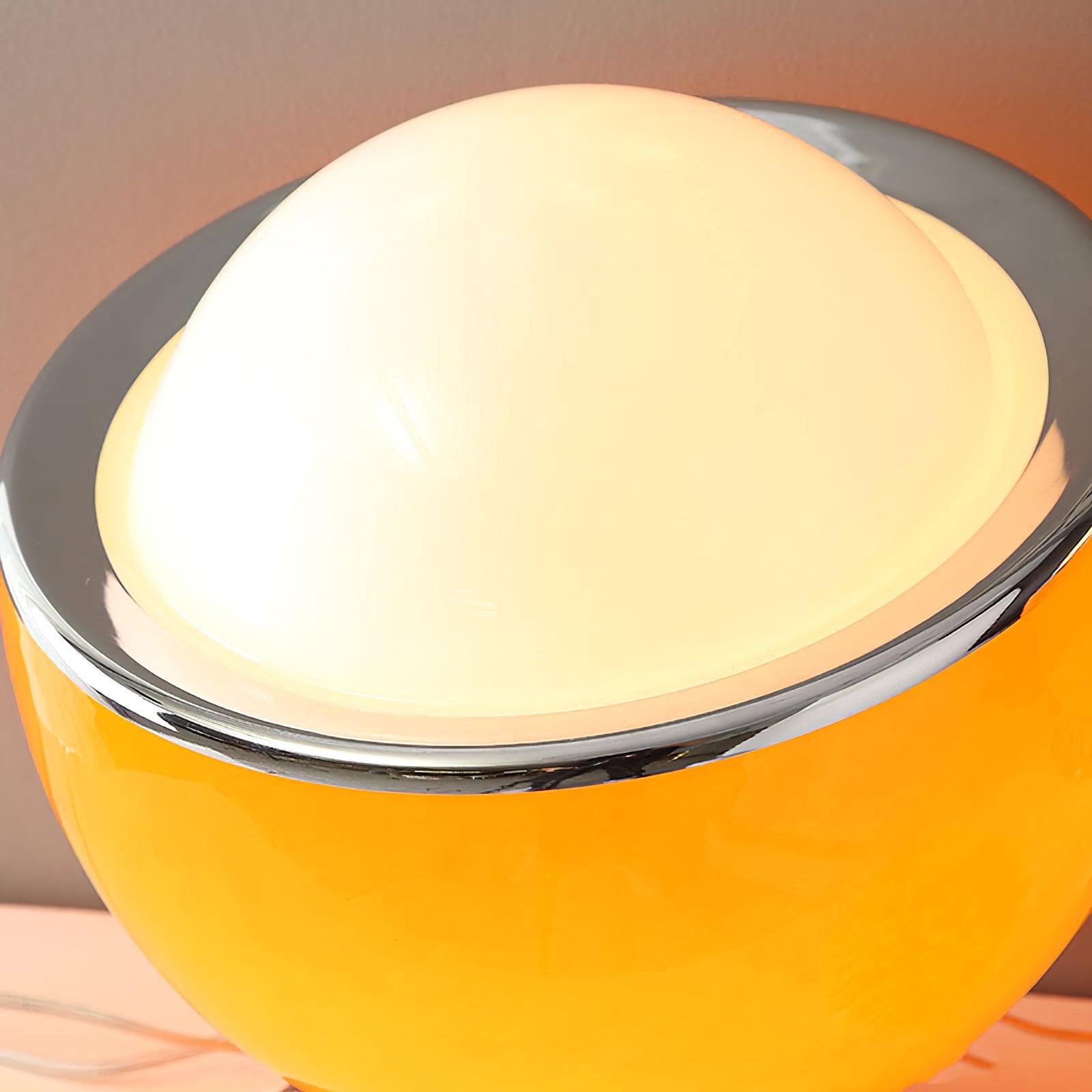 Illuminated pale dome above the orange-toned Valeria shade