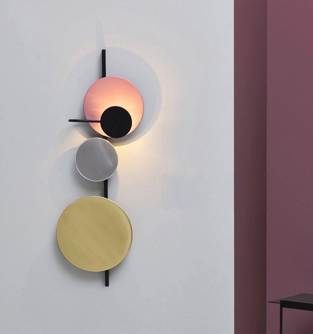 Pink-toned disc arrangement beside a doorway