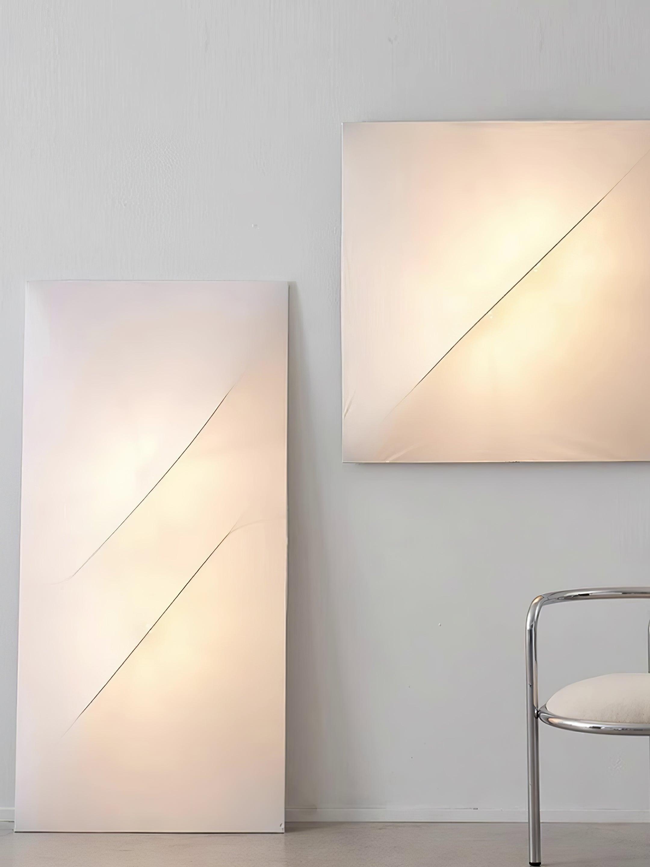 Lit rectangle and square wall panels showing diagonal surface lines and warm-looking fabric faces