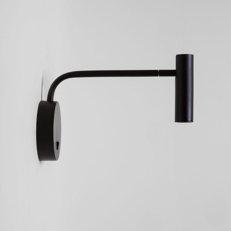 Side view of black arm and round backing