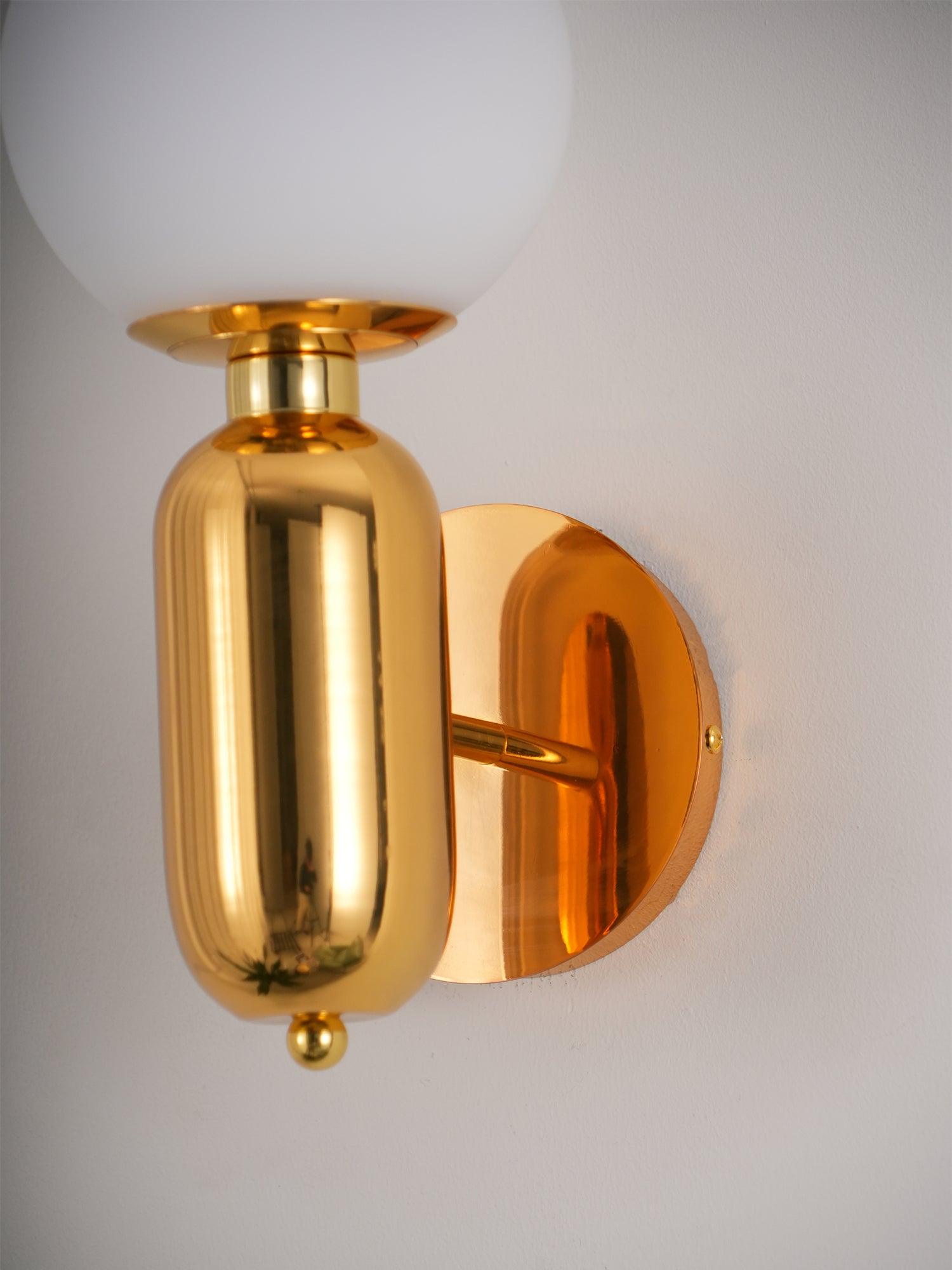 Close view of gold-toned rounded body, collar, short arm and circular backplate with side screw, globe cropped