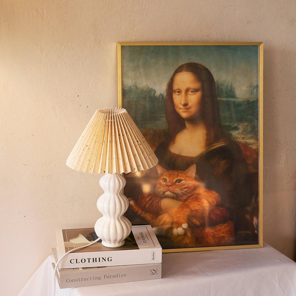 Leo patterned shade lamp beside a framed portrait print