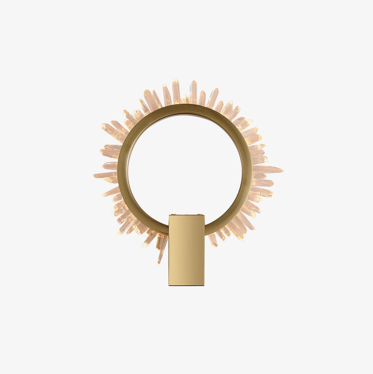 Small isolated front view of a gold-finish ring and clear crystal rim with a lower rectangular mount