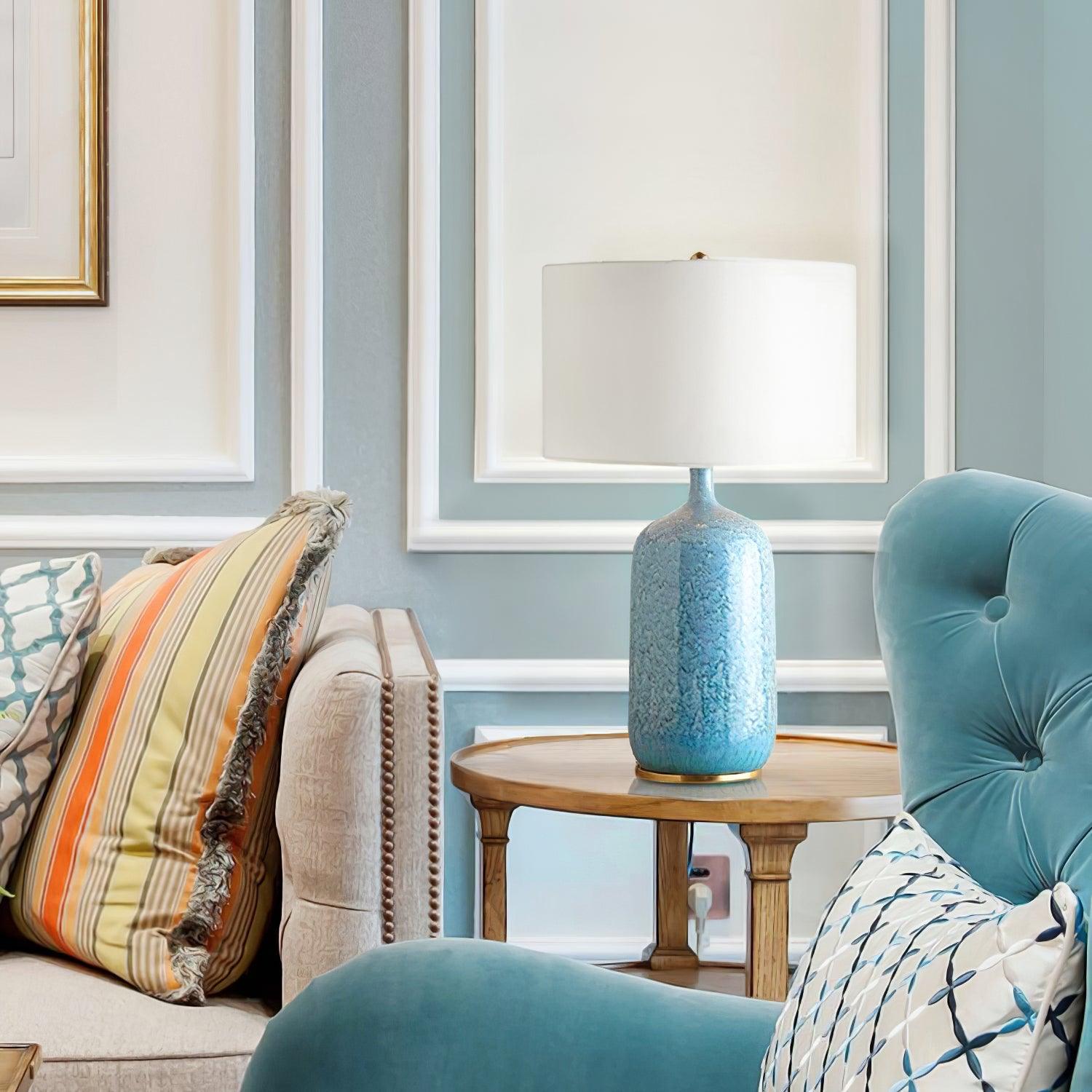 Culloden table lamp on a round table beside a blue chair