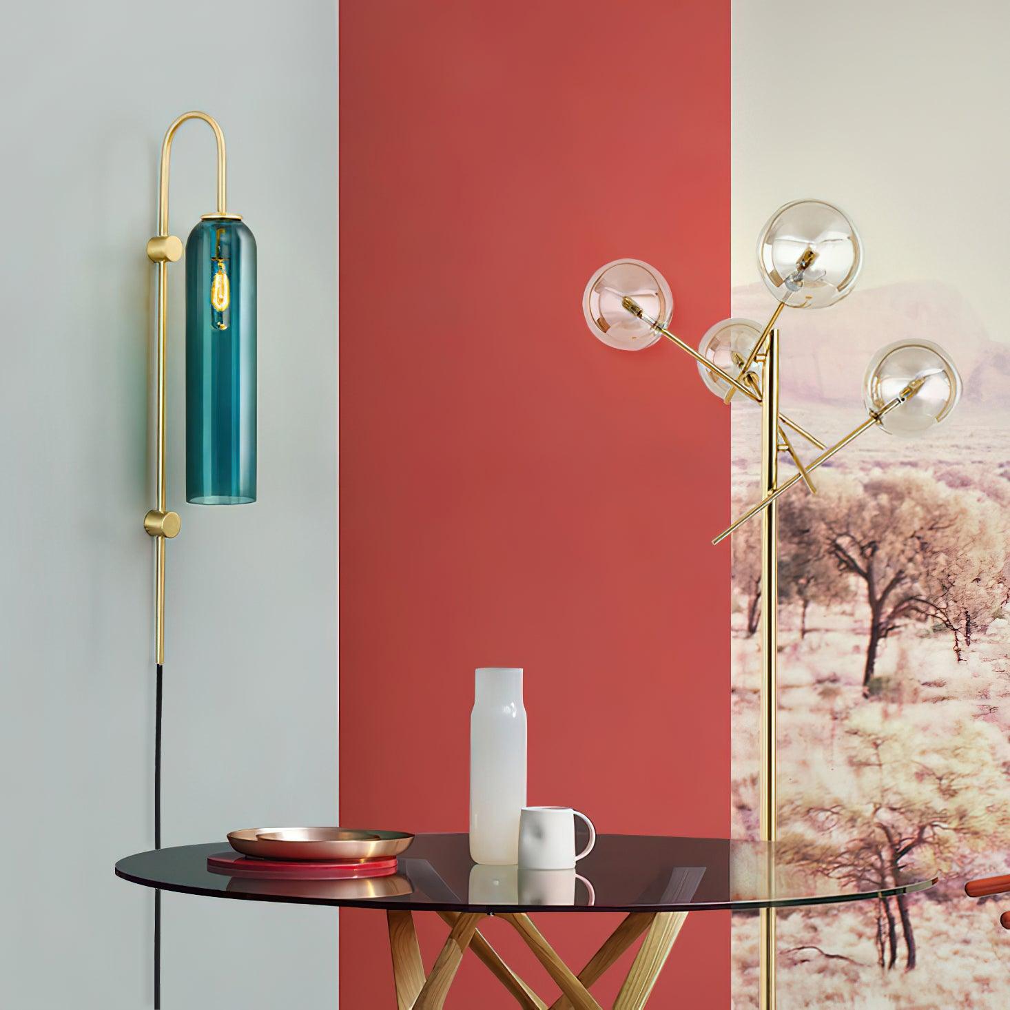 Gold and dark teal wall lamp beside a red accent wall