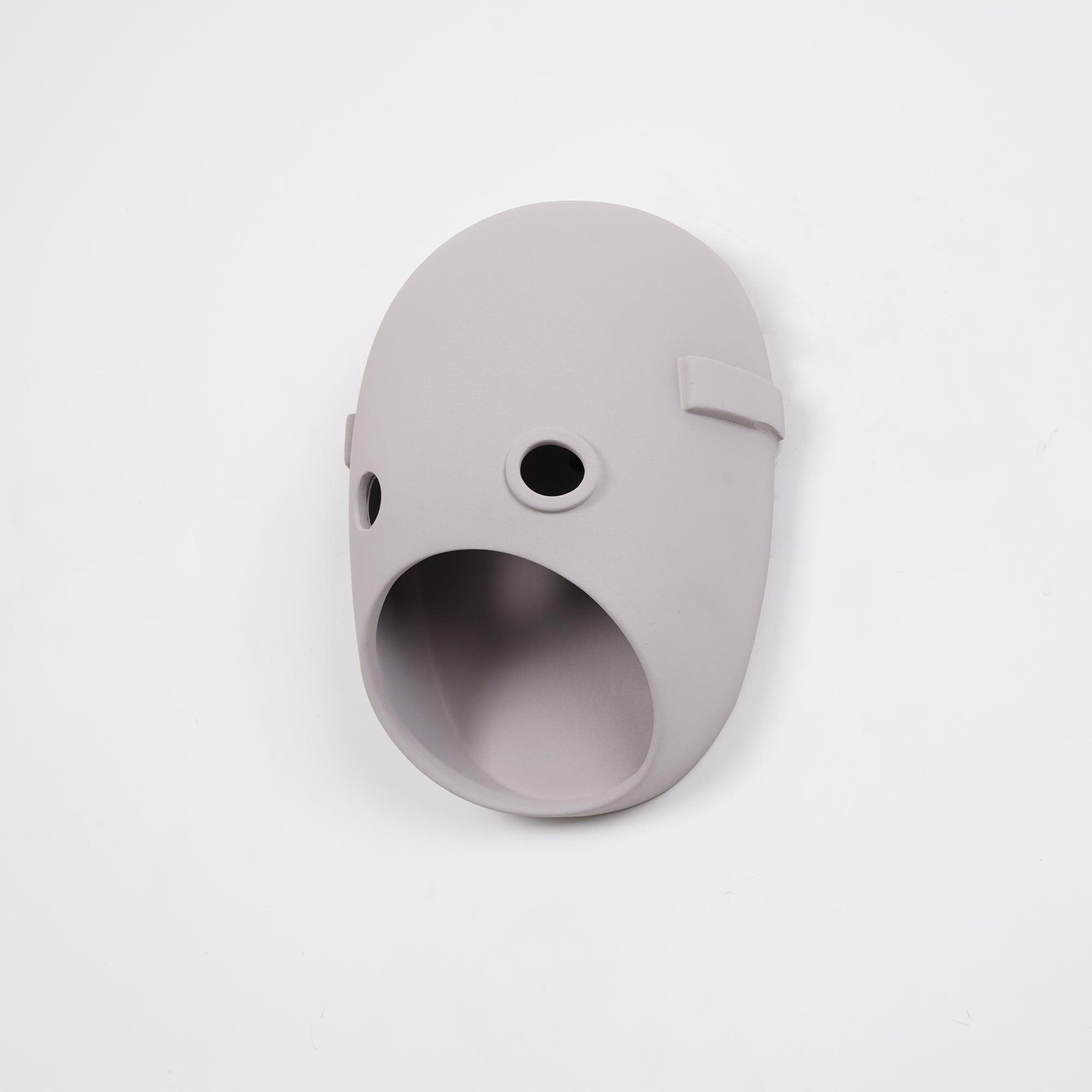 Angled view of an unlit face wall light