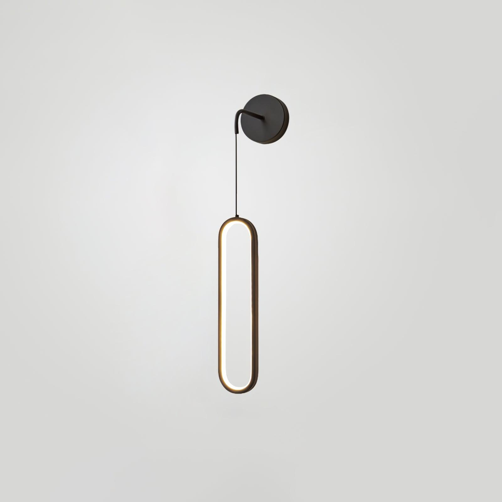 Dark round wall plate and short arm above a suspended oval ring with gold-toned edging