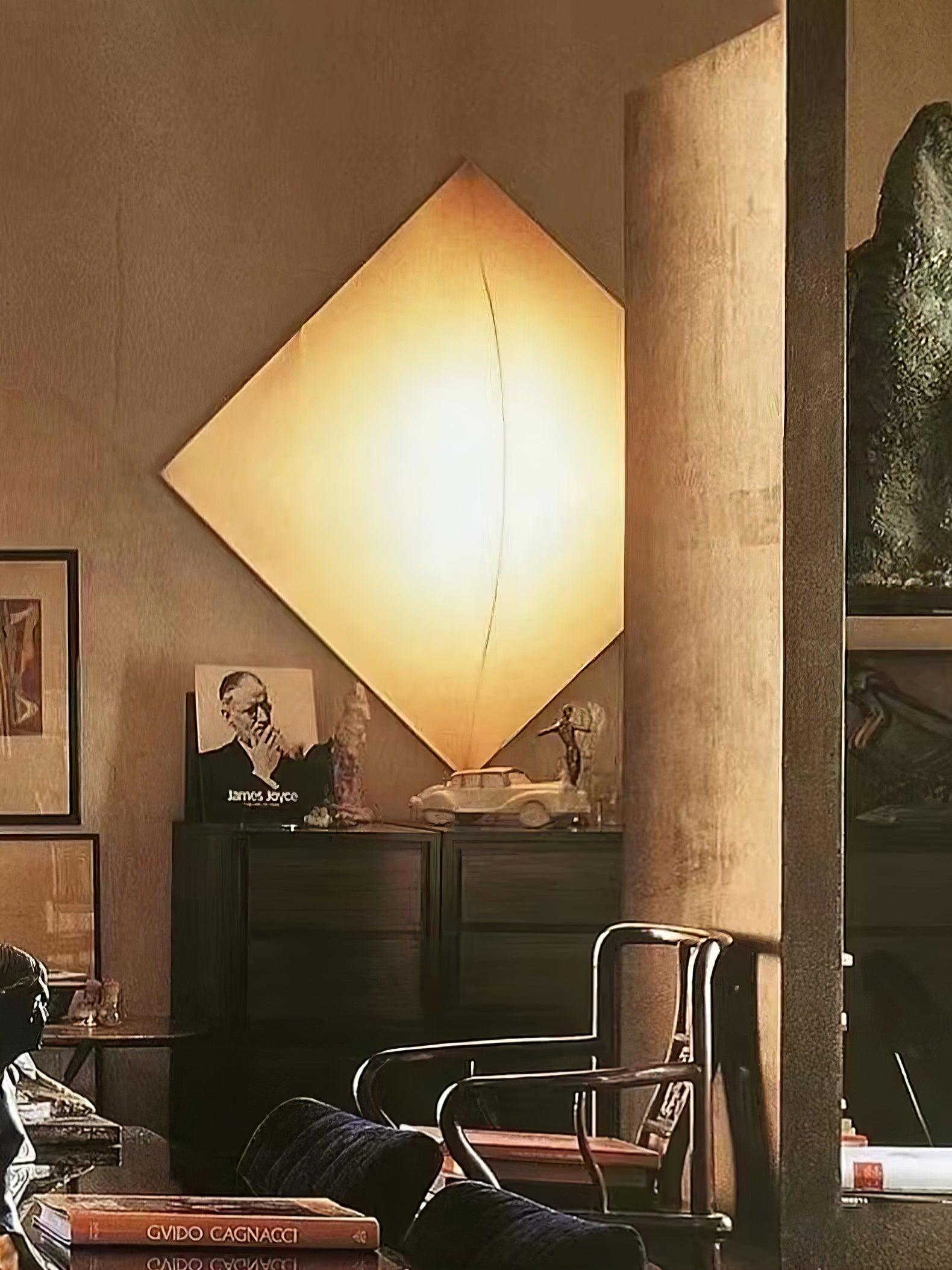 Wide interior view of a glowing diamond-oriented panel above a cabinet and model car near wooden chairs