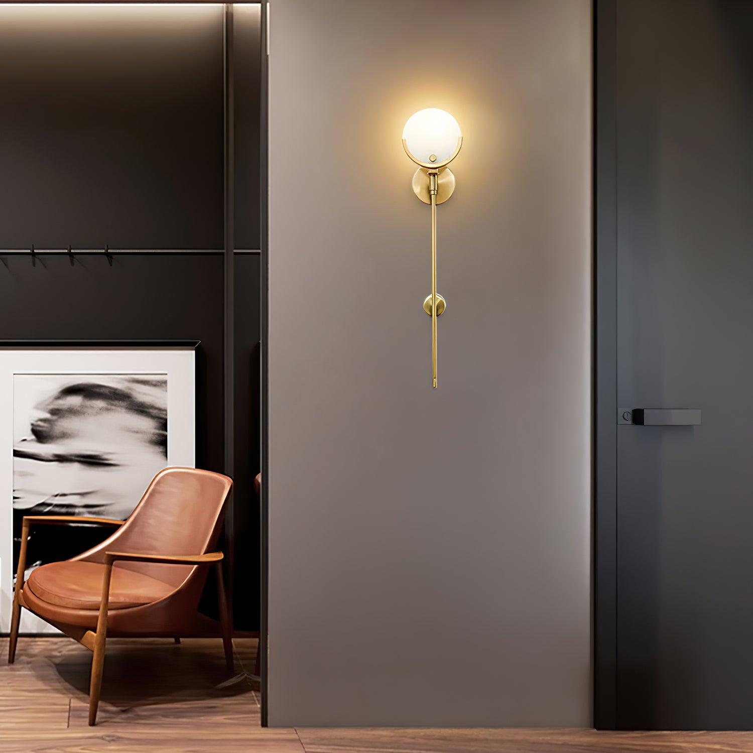 Lit long-stem Ava fixture beside a dark interior door and a seating niche with a brown chair