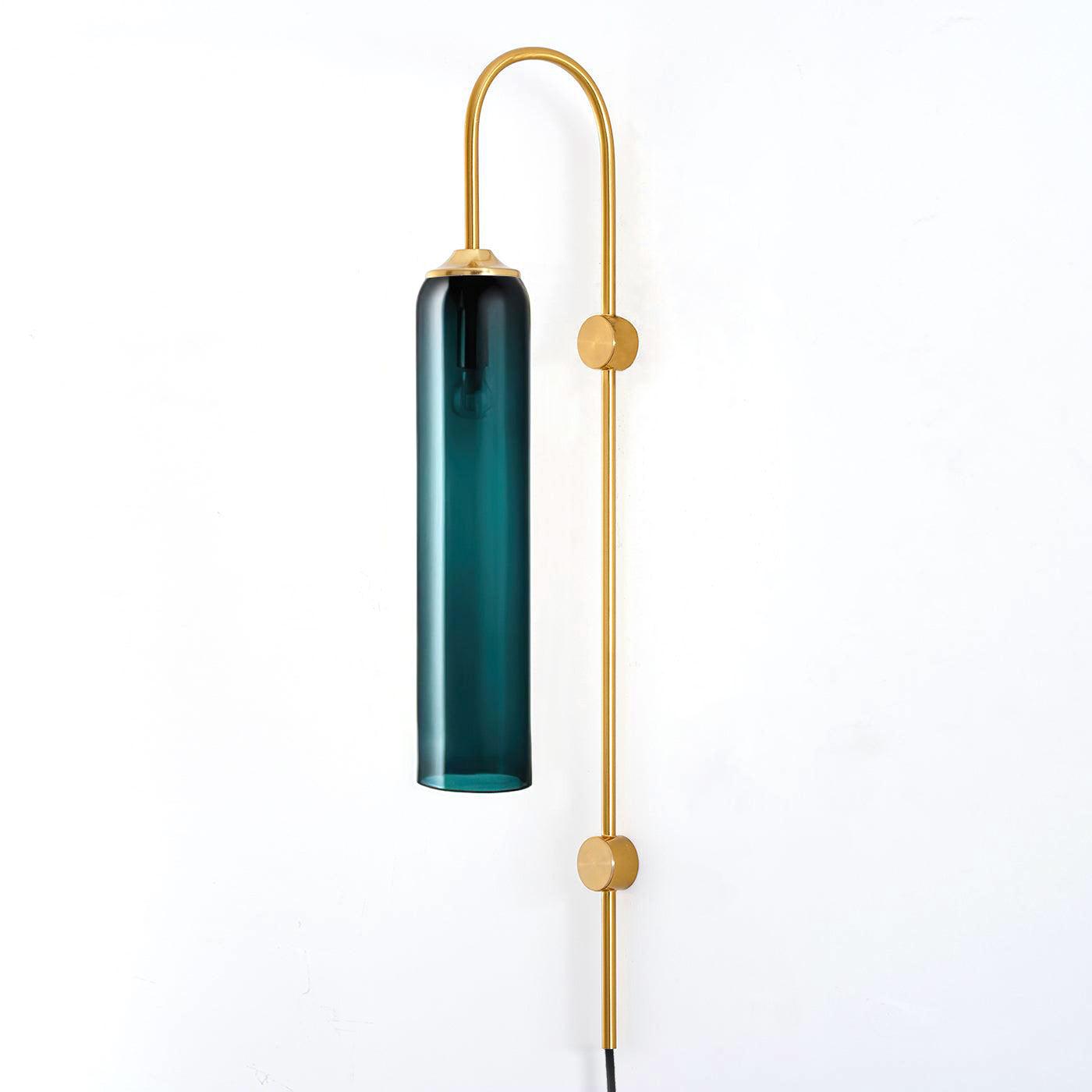 Dark teal cylindrical shade on a Gold wall stem